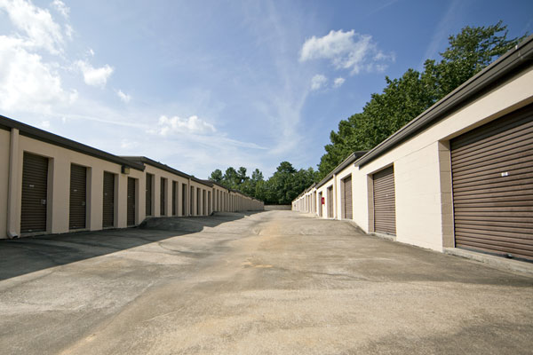 A row of storage units in an empty lot.