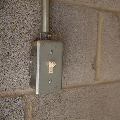 A light switch hanging on the wall.